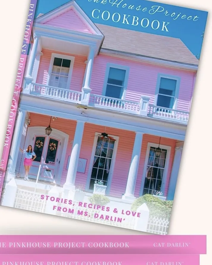 Cover of The PinkHouse Project Cookbook, a pink two-storey house